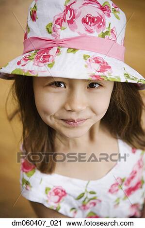 Close up of Asian girl wearing hat View Large Photo Image Stock Image - Close up of Asian girl wearing hat. Fotosearch