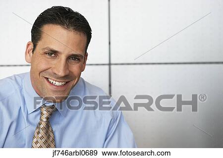 Close up of businessman smiling View Large Photo Image Stock Photo - Close up of businessman smiling. Fotosearch