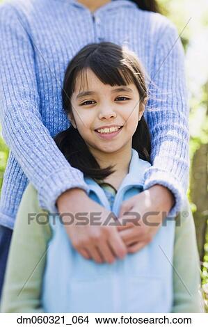 Close up of Hispanic girl with mother View Large Photo Image Picture - Close up of Hispanic girl with mother. Fotosearch