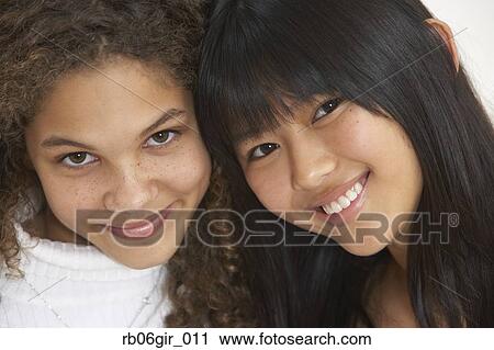 Close up of two girls smiling View Large Photo Image Stock Image - Close up of two girls smiling. Fotosearch