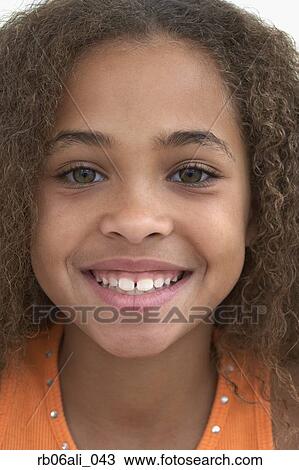 Close up of young African American girl smiling View Large Photo Image Stock Image - Close up of young African American girl smiling. Fotosearch