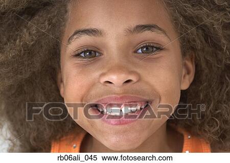 Close up of young African American girl smiling View Large Photo Image Stock Photography - Close up of young African American girl smiling. Fotosearch