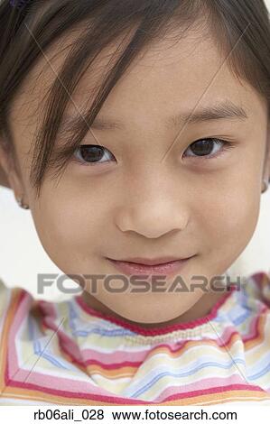 Stock Photo - Close up of young Asian girl smiling. Fotosearch