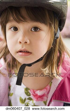 Close up of young Asian girl wearing bicycle helmet View Large Photo Image Stock Photo - Close up of young Asian girl wearing bicycle helmet. Fotosearch