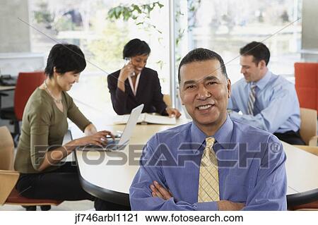 Group of businesspeople in office View Large Photo Image Stock Image - Group of businesspeople in office. Fotosearch