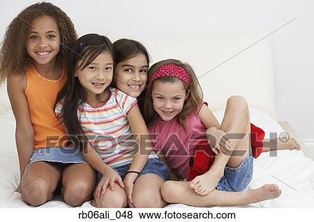 Group of young girls hugging and smiling View Large Photo Image Stock Photo - Group of young girls hugging and smiling. Fotosearch