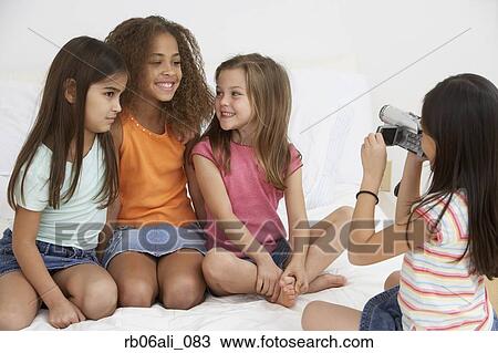Group of young girls using video camera View Large Photo Image Stock Image - Group of young girls using video camera. Fotosearch