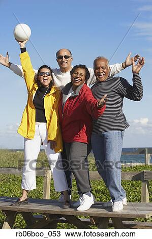 Stock Image - Group senior friends with volley ball. Fotosearch