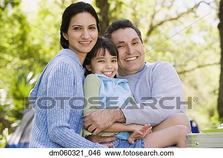 Hispanic family hugging outdoors View Large Photo Image Stock Photograph - Hispanic family hugging outdoors. Fotosearch