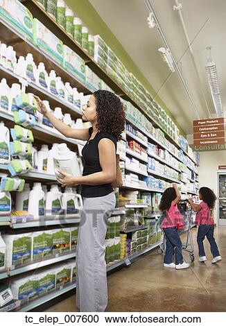 Stock Image - Mother with young daughters in grocery store. Fotosearch
