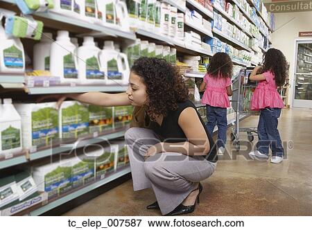 Stock Photo - Mother with young daughters in grocery store. Fotosearch