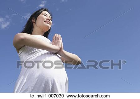 Pregnant Asian woman doing yoga outdoors View Large Photo Image Stock Image - Pregnant Asian woman doing yoga outdoors. Fotosearch