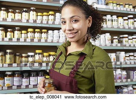 Stock Image - Saleswoman in health food store. Fotosearch