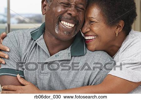 Stock Photography - Senior African American couple hugging. Fotosearch - Search Stock Photos, Pictures, Wall Murals, Images, and Photo Clipart