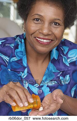 Senior African American woman with medication View Large Photo Image Stock Photo - Senior African American woman with medication. Fotosearch