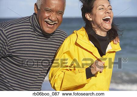 Senior couple laughing at beach View Large Photo Image Stock Photo - Senior couple laughing at beach. Fotosearch