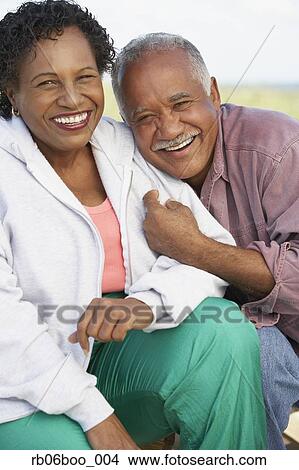Picture - Senior couple smiling and hugging outdoors. Fotosearch