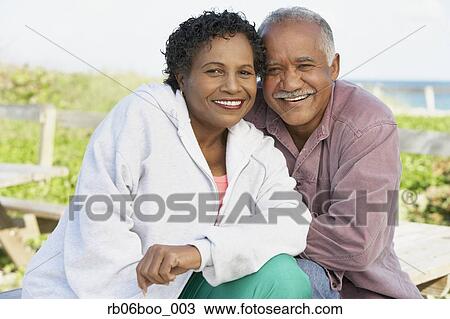 Senior couple smiling and hugging outdoors View Large Photo Image Stock Image - Senior couple smiling and hugging outdoors. Fotosearch