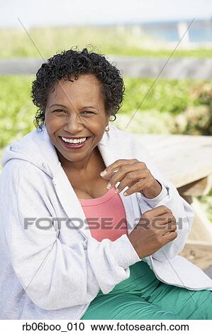 Stock Image - Senior woman laughing outdoors. Fotosearch