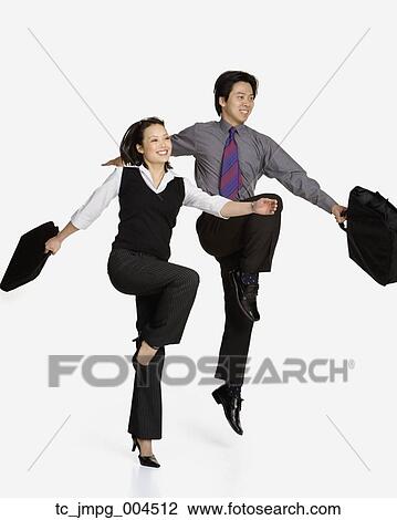 Studio shot of Asian businesspeople skipping View Large Photo Image Stock Image - Studio shot of Asian businesspeople skipping. Fotosearch