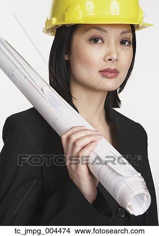 Studio shot of Asian businesswoman wearing a hard hat View Large Photo Image Picture - Studio shot of Asian businesswoman wearing a hard hat. Fotosearch