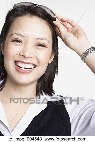 Stock Photo - Studio shot of Asian businesswoman smiling. Fotosearch