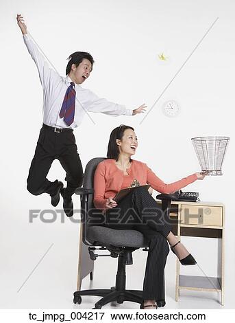 Stock Photo - Studio shot of happy Asian businesspeople . Fotosearch