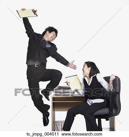 Stock Image - Studio shot of happy businesspeople . Fotosearch