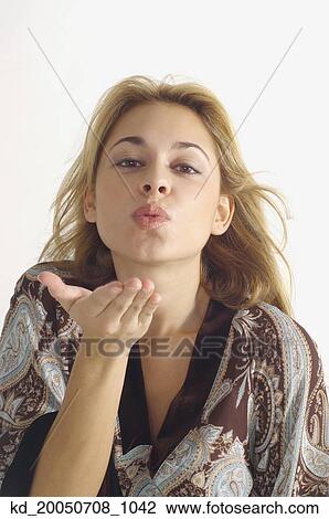 Studio shot of woman blowing kiss View Large Photo Image Stock Image - Studio shot of woman blowing kiss. Fotosearch