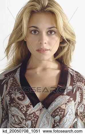 Stock Image - Studio shot of woman looking serious. Fotosearch