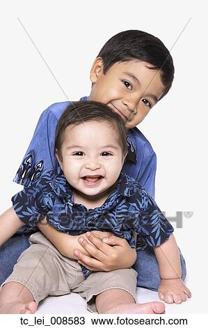 Studio shot of young boy with baby brother View Large Photo Image Stock Image - Studio shot of young boy with baby brother. Fotosearch