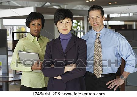 Three businesspeople in office View Large Photo Image Stock Photograph - Three businesspeople in office. Fotosearch
