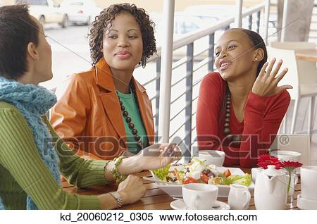 Three women eating and talking View Large Photo Image Stock Photography - Three women eating and talking . Fotosearch