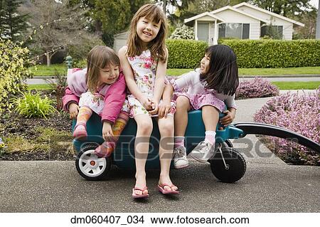 Picture - Three young Asian girls in wagon. Fotosearch