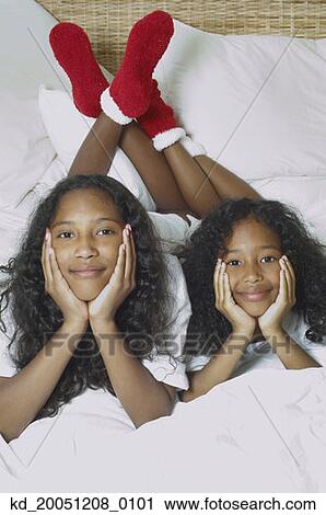 Two African American sisters on bed View Large Photo Image Stock Image - Two African American sisters on bed. Fotosearch