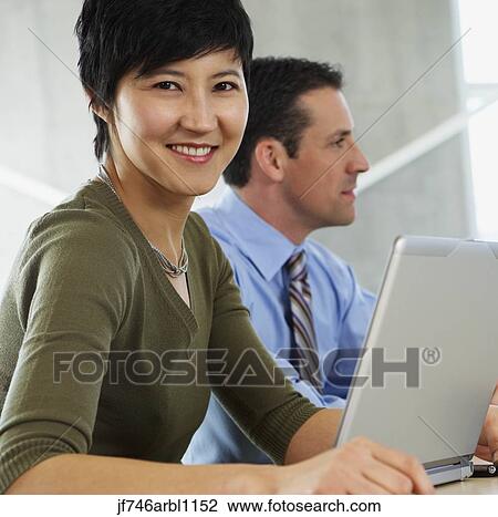 Two businesspeople in office View Large Photo Image Stock Image - Two businesspeople in office. Fotosearch