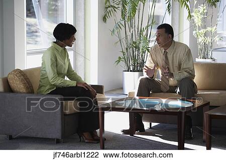 Two businesspeople talking View Large Photo Image Stock Image - Two businesspeople talking. Fotosearch