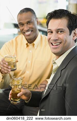 Two men smiling with drinks View Large Photo Image Stock Image - Two men smiling with drinks. Fotosearch