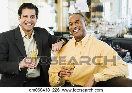 Two men with drinks at bar View Large Photo Image Stock Photograph - Two men with drinks at bar. Fotosearch