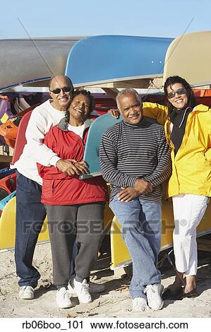 Two senior couples in front of canoes at beach View Large Photo Image Stock Image - Two senior couples in front of canoes at beach. Fotosearch