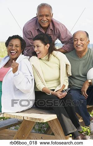 Two senior couples laughing outdoors View Large Photo Image Stock Photo - Two senior couples laughing outdoors. Fotosearch