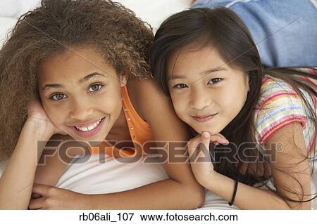 Two young girls smiling View Large Photo Image Stock Photo - Two young girls smiling. Fotosearch