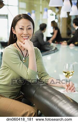 Woman at bar with glass of wine View Large Photo Image Stock Image - Woman at bar with glass of wine. Fotosearch