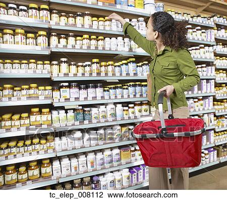 Woman shopping for vitamins View Large Photo Image Stock Image - Woman shopping for vitamins. Fotosearch