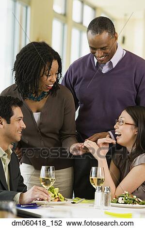 Woman showing friends her engagement ring View Large Photo Image Stock Image - Woman showing friends her engagement ring. Fotosearch