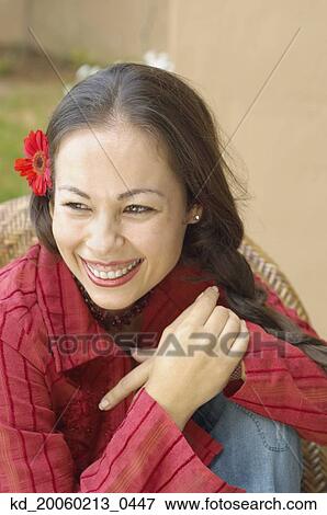 Woman smiling with flower in her hair View Large Photo Image Stock Photo - Woman smiling with flower in her hair. Fotosearch
