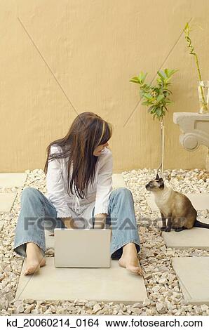 Woman with laptop and cat outdoors View Large Photo Image Picture - Woman with laptop and cat outdoors. Fotosearch