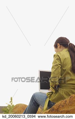 Woman with laptop outdoors View Large Photo Image Picture - Woman with laptop outdoors. Fotosearch