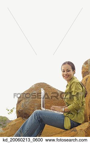 Woman with laptop outdoors View Large Photo Image Stock Image - Woman with laptop outdoors. Fotosearch