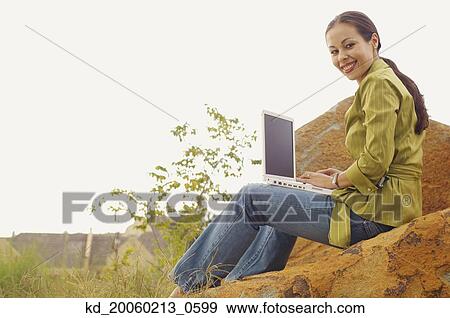 Woman with laptop outdoors View Large Photo Image Stock Photo - Woman with laptop outdoors. Fotosearch